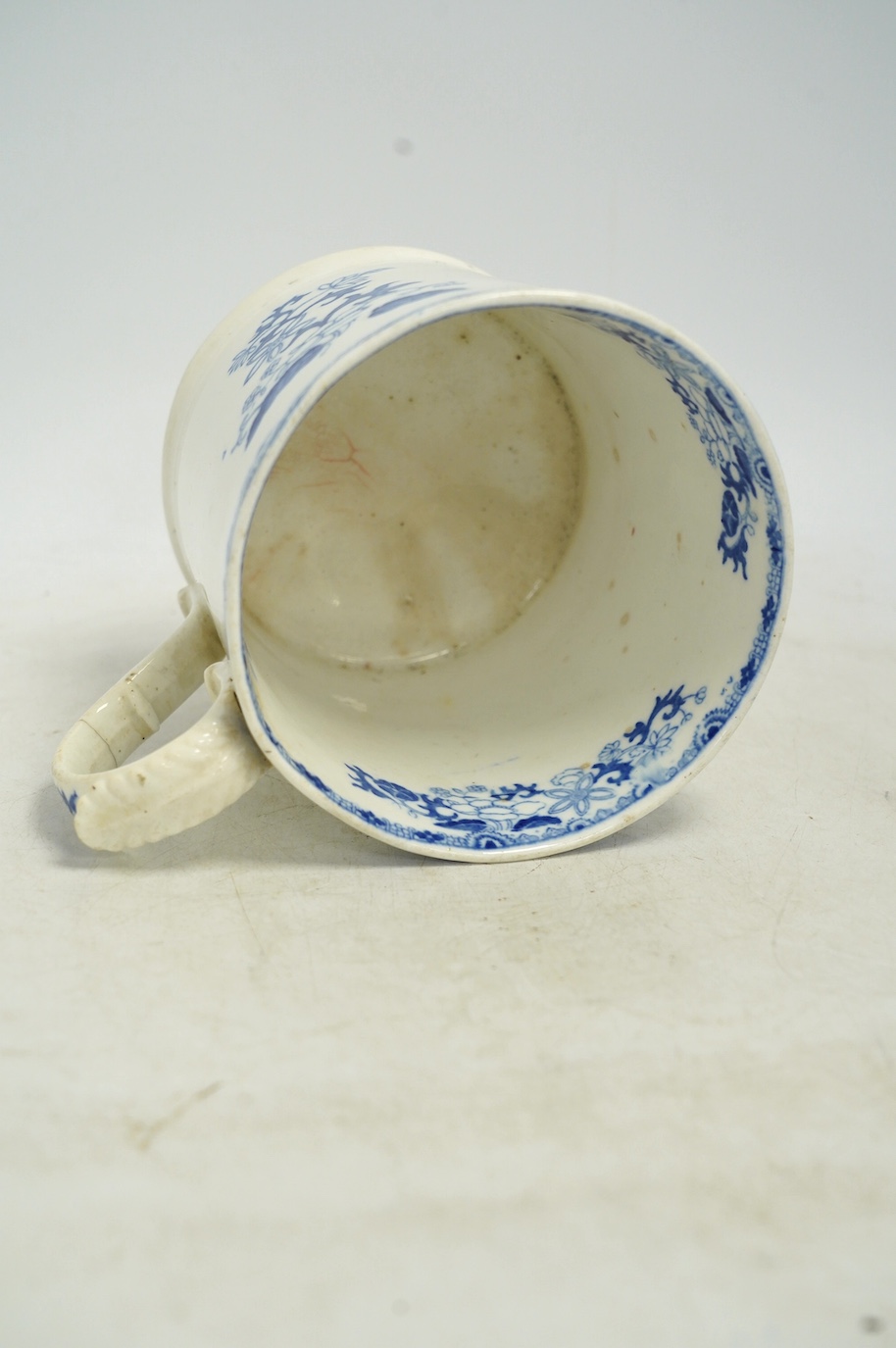 An early Victorian blue and white bone china mug, 13cm high. Condition - fair, crack to the handle
